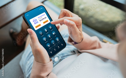 Woman using smartphone to conduct online mobile banking. Business and technology concept photo