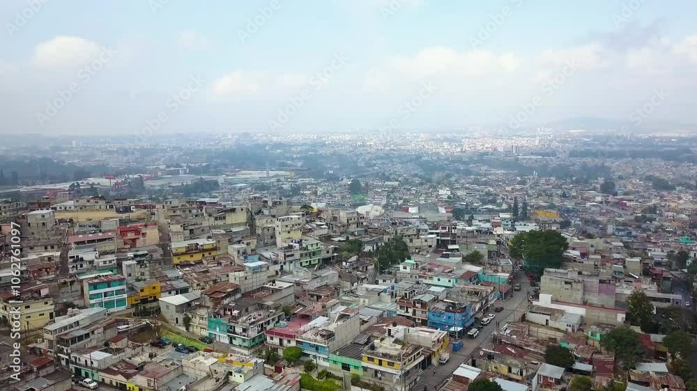 Guatemala City, Zone 18 aerial view of hill filled with small concrete makeshift low income high density households and horizon in the background - Drone slow orbit shot Guatemala City, Zone 18 aerial view of hill filled with small concrete makeshift low income high density households and horizon in the background - Drone slow orbit shot