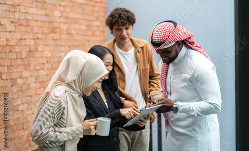 Wallpaper Mural Multicultural business team discussing project with digital tablet, arab businessman traditional attire collaborating with asian and caucasian colleagues, teamwork, business strategy, and technology Torontodigital.ca