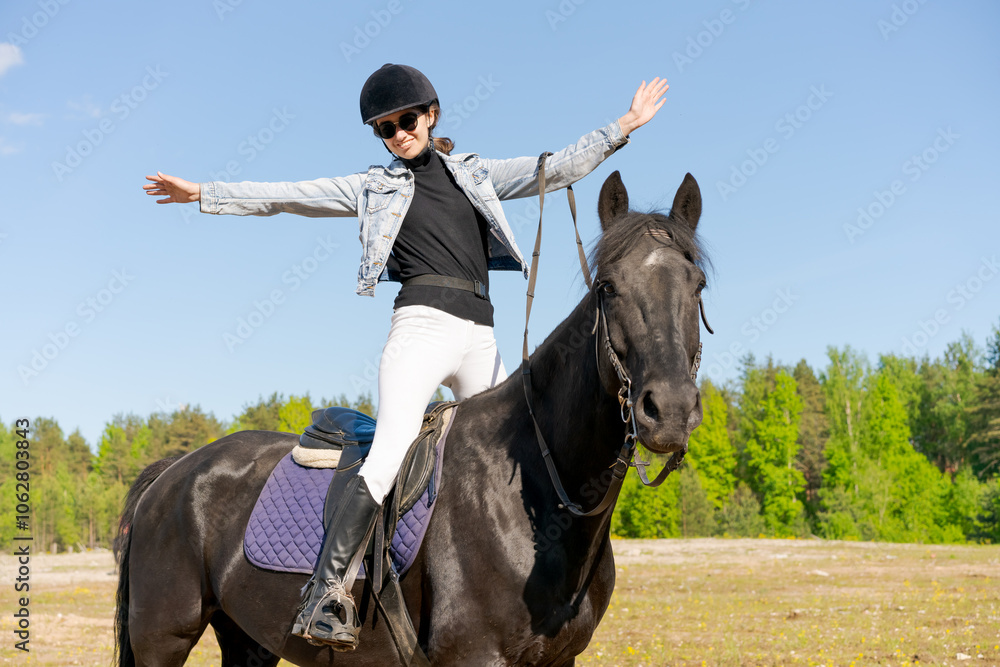 Woman is riding a horse in a field Woman is riding a horse in a field