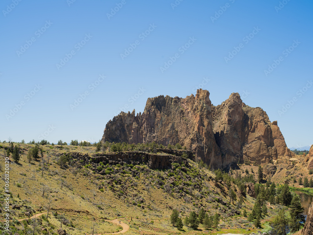 A mountain range with a clear blue sky in the background