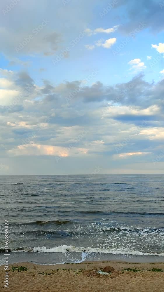 Dark storm clouds, rain and sea surface at sunset. Nature. Natural background. Stormy weather. Storm at sea. Vertical Dark storm clouds, rain and sea surface at sunset. Nature. Natural background. Stormy weather. Storm at sea. Vertical