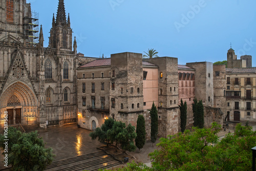 Evening view on a rainy evening of the facade of the Gothic Barcelona Cathedral of the Holy Cross and Saint Eulalia and the plaza in the El Born district of Barcelona, Spain. photo