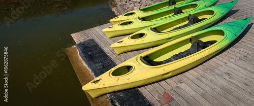 RECREATIONAL KAYAKS - Colorful boats on a wooden pier on the lake
 photo