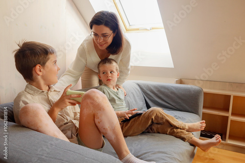 Children show something to their mother on the phone screen photo