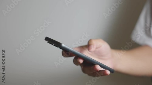 Middle-aged man in white shirt using smartphone on white background