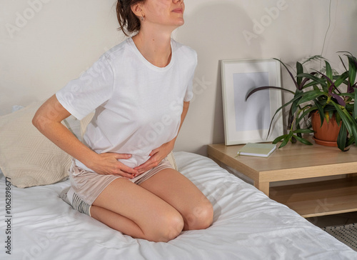 Gynecological problems or menstrual disorder. Woman holding crotch, stomachache symptom, genital pain. Woman experiencing discomfort during menstruation photo