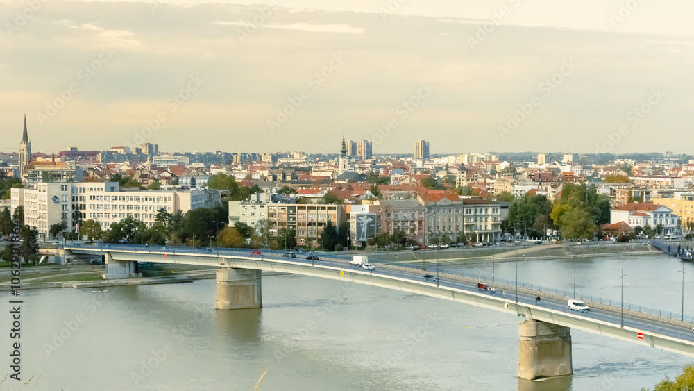 Obraz premium cityscape of Novi Sad from the historic vantage point of Petrovaradin, where ancient towers and charming streets intertwine with the gentle flow of the Danube.