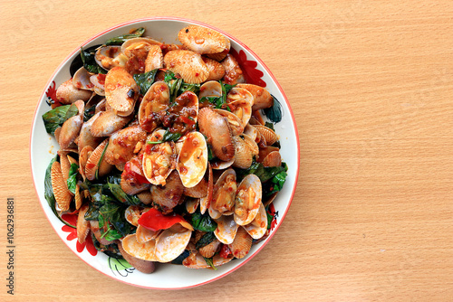 Stir fried striped clams with basil, chilli paste, garlic and fresh chilies