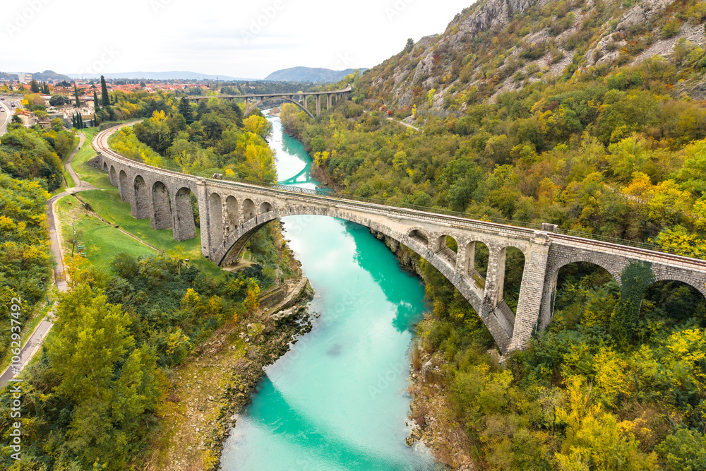 Slovenia. Aerial view of beautiful Solkan Rail Stone Bridge over Soca river with turquoise water. World largest arch stone rail bridge at autumn time Slovenia. Aerial view of beautiful Solkan Rail Stone Bridge over Soca river with turquoise water. World largest arch stone rail bridge at autumn time