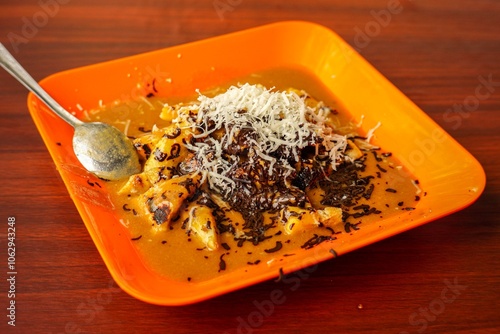 Pisang Gapit (Roasted Banana) is a typical Banjarmasin food, this food consists of bananas that are clamped, served with peanut sauce, chocolate and cheese. photo