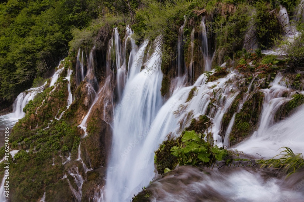 Waterfall cascading over lush green cliffs. Waterfall cascading over lush green cliffs.