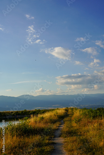 Path along the Belizmata Dam with a backdrop of the Pirin Mountains, Bansko, Bulgaria