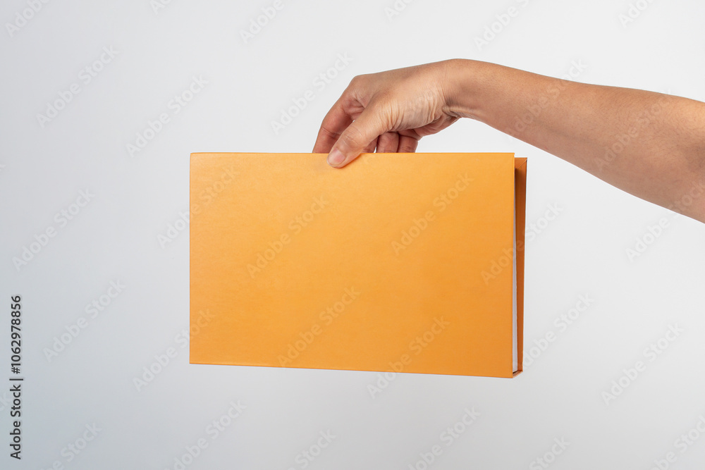 Blank book cover in hand on white background. Blank book cover in hand on white background.