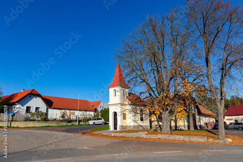 Obraz na płótnie A small chapel in a Czech village Breznice on an autumn day. w salonie