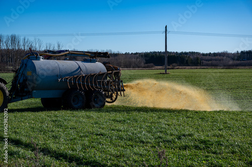 farmer spreads manure on farmland Hallsberg Sweden photo