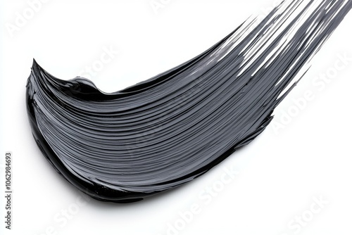 A brush stroke of black paint on a white background