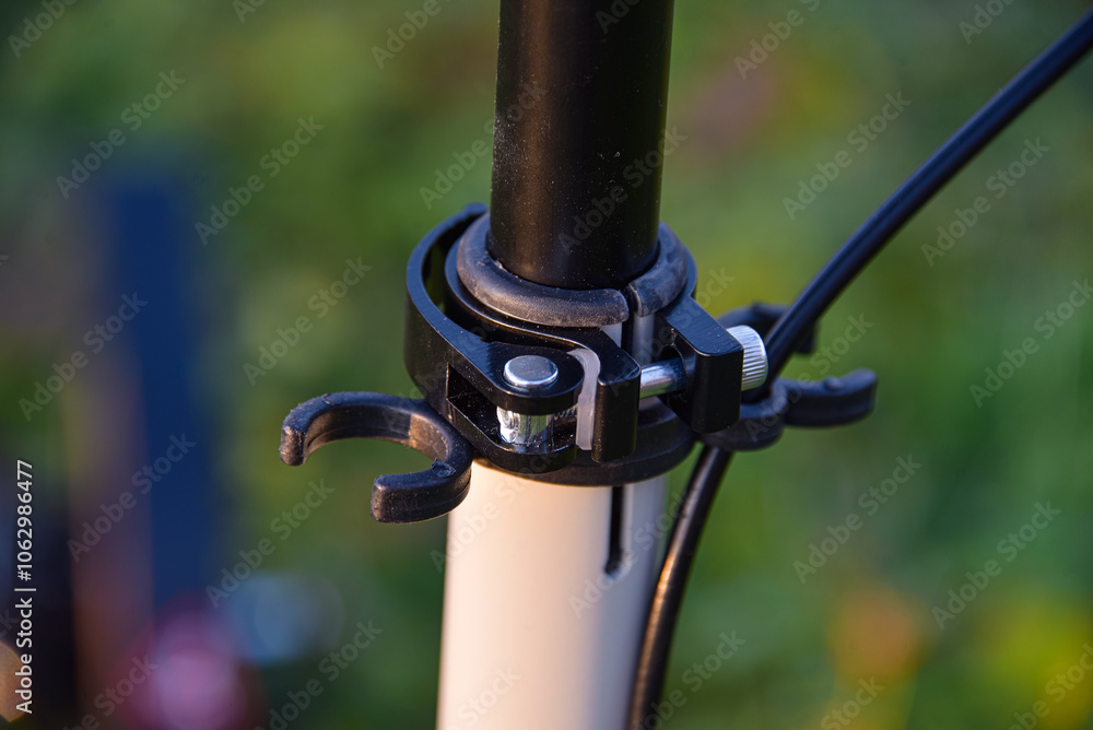 Obraz premium Clamp for adjusting the height of the handlebars on a scooter with holders.