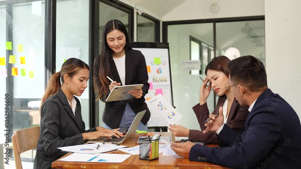 Asian Business Group Chat about graph work Present in meetings, in the office Asian Business Group Chat about graph work Present in meetings, in the office