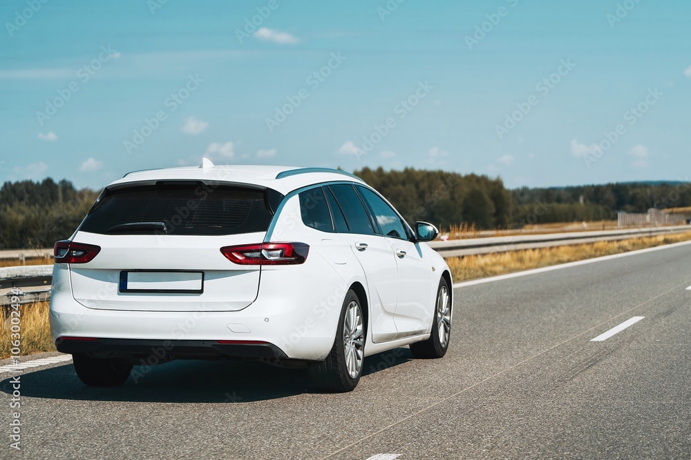 White estate car traveling on clear highway White estate car traveling on clear highway