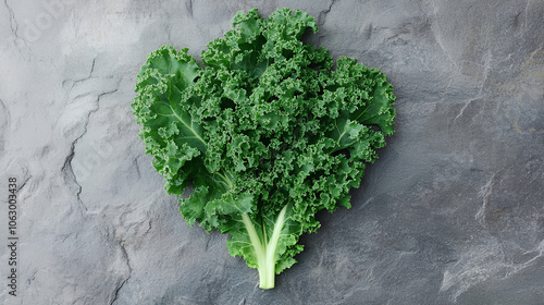 Curly Kale. Fresh raw Curly Kale leaves on gray stone background, top view. Ready for delicious healthy salad, vegan food, superfood.