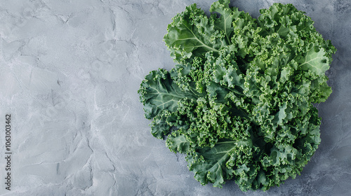 Curly Kale. Fresh raw Curly Kale leaves on gray stone background, top view. Ready for delicious healthy salad, vegan food, superfood.
