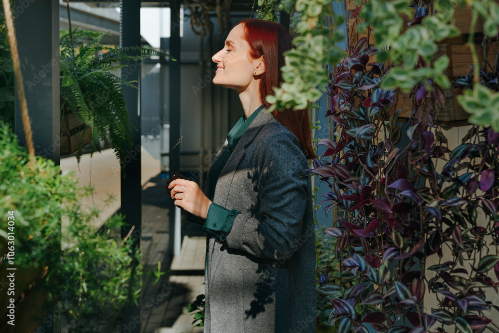 Smiling businesswoman with eyes closed in urban garden at office Smiling businesswoman with eyes closed in urban garden at office