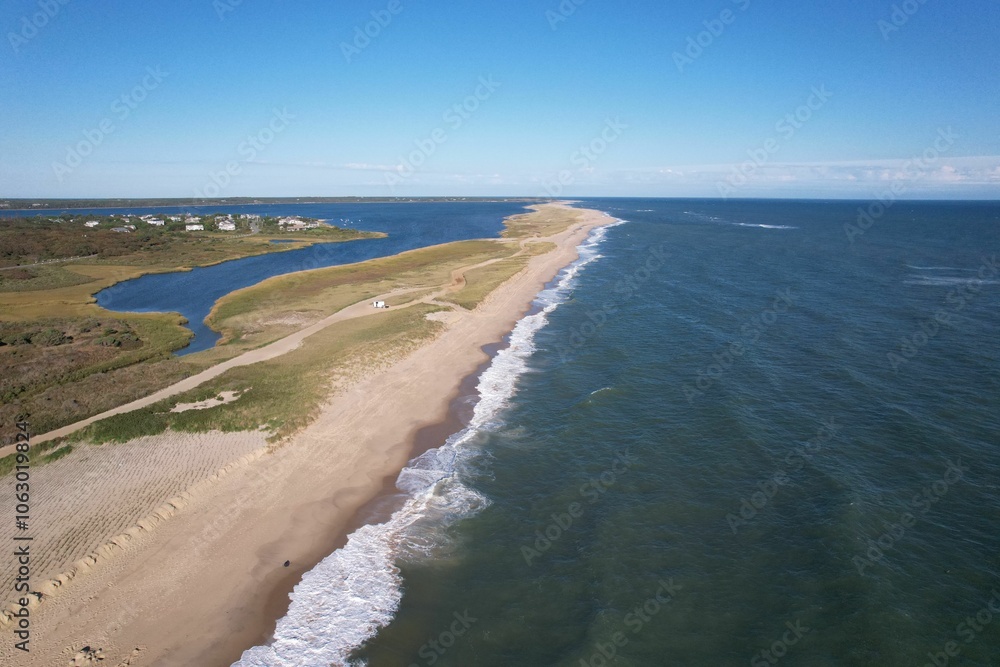 Aerial view of a coastal landscape with a sandy beach and ocean waves. Aerial view of a coastal landscape with a sandy beach and ocean waves.