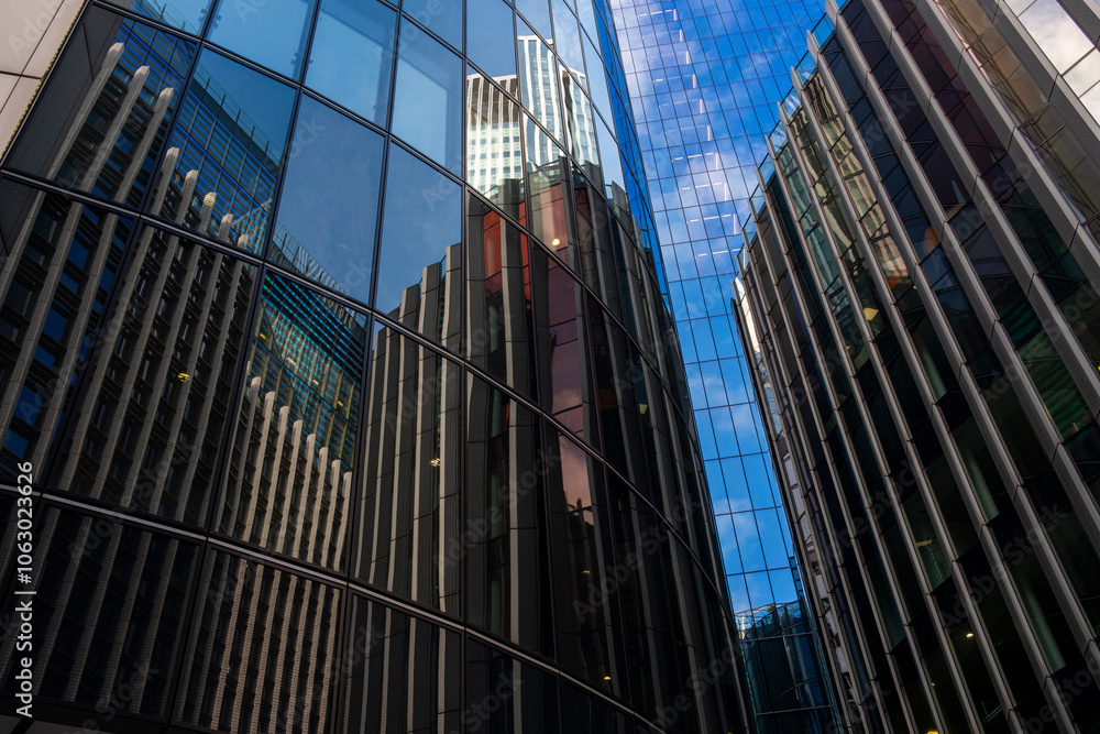 A captivating image of a curved glass building displaying intricate reflections of neighboring structures, blending urban architecture with artistic visual interplay in London UK A captivating image of a curved glass building displaying intricate reflections of neighboring structures, blending urban architecture with artistic visual interplay in London UK