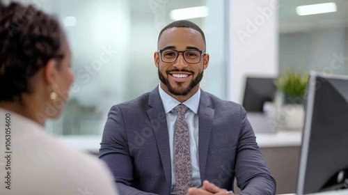 Professional businessman smiling during a meeting with a client in modern office environment