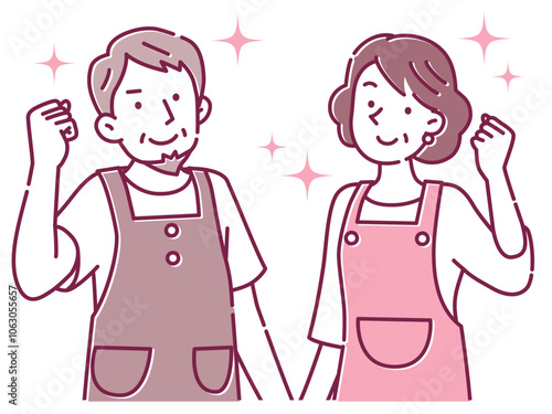 笑顔でガッツポーズするエプロン姿の中年の夫婦