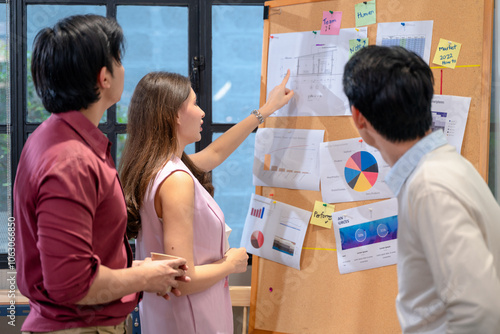 Businesswoman giving presentation to colleague in office meeting.