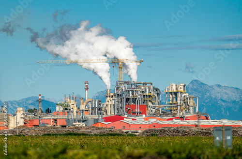 Heavy smoking chimneys in industrial plant photo