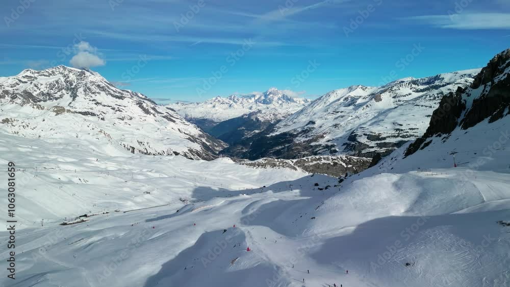 Val d'Isere, France: Aerial view of famous bustling ski resort in French Alps. Snow-covered slopes with ski runs, sunny day with clear blue sky - landscape panorama of Europe from above
Val d'Isere, France: Aerial view of famous bustling ski resort in French Alps. Snow-covered slopes with ski runs, sunny day with clear blue sky - landscape panorama of Europe from above