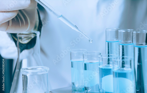 Researcher with glass laboratory chemical test tubes with liquid for analytical , medical, pharmaceutical and scientific research concept.