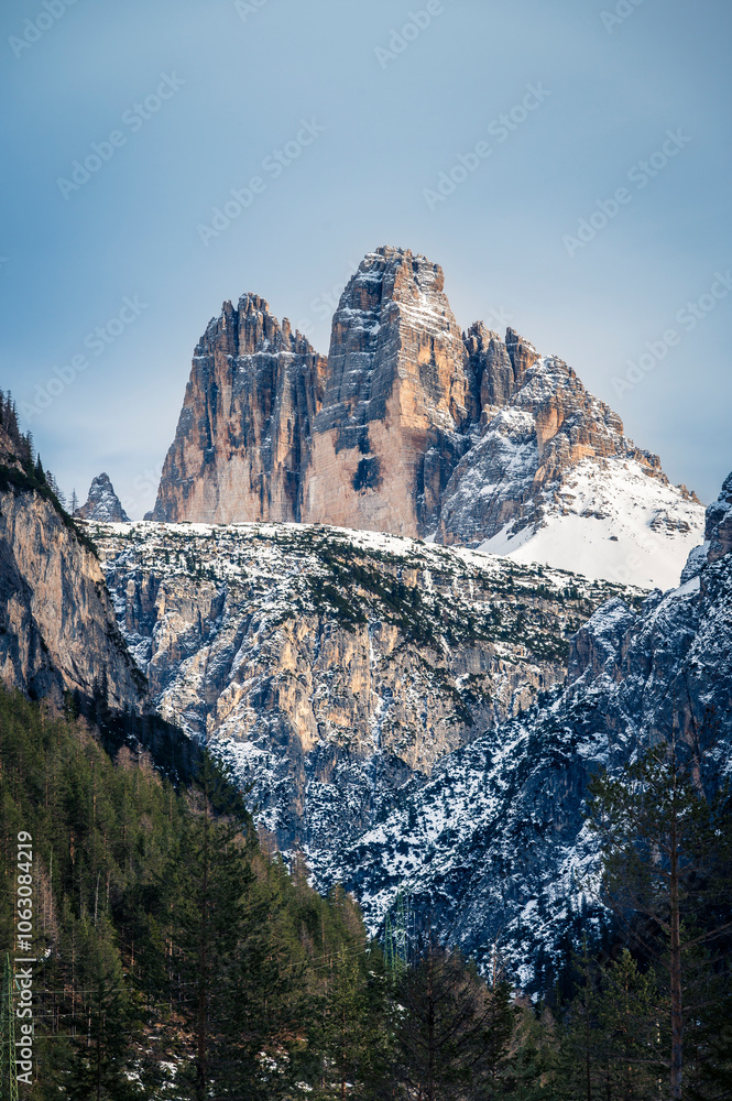 Dolomites at sunset. Winter and clear atmosphere between peaks and spires. Tre Cime di Lavaredo Dolomites at sunset. Winter and clear atmosphere between peaks and spires. Tre Cime di Lavaredo