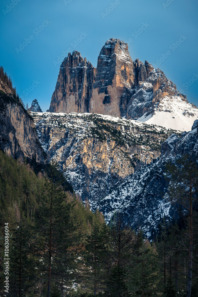 Dolomites at sunset. Winter and clear atmosphere between peaks and spires. Tre Cime di Lavaredo Dolomites at sunset. Winter and clear atmosphere between peaks and spires. Tre Cime di Lavaredo