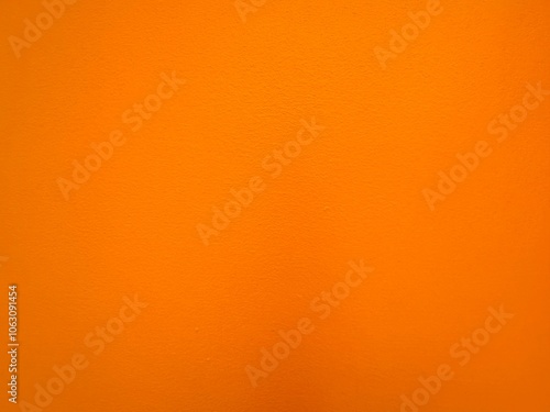 Wall painted in bright and warm orange tone for background and decorations