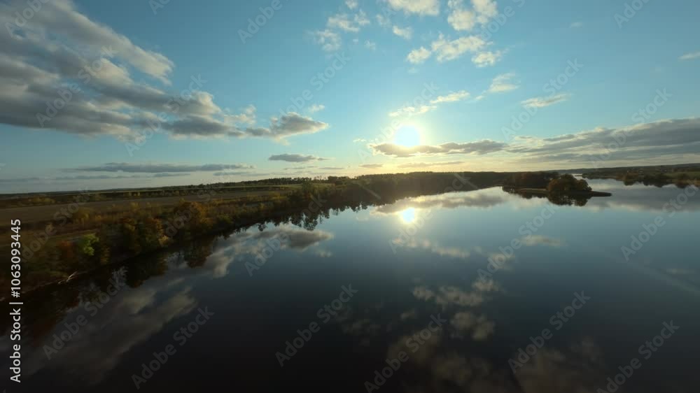 FPV drone gliding over Sunowo Lake in Elk, Poland, in vibrant autumn hues. FPV drone gliding over Sunowo Lake in Elk, Poland, in vibrant autumn hues.