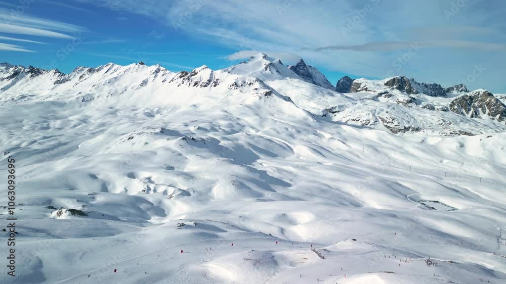 Val d'Isere, France: Aerial view of famous bustling ski resort in French Alps. Snow-covered slopes with ski runs, sunny day with clear blue sky - landscape panorama of Europe from above
Val d'Isere, France: Aerial view of famous bustling ski resort in French Alps. Snow-covered slopes with ski runs, sunny day with clear blue sky - landscape panorama of Europe from above