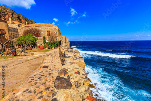Fototapeta Naklejka Na Ścianę i Meble -  Monemvasia sea and street panorama with old houses, trees in ancient town, Peloponnese, Greece