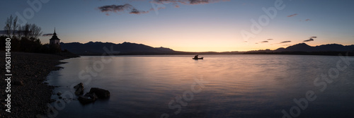 Early morning view of Liptovska Mara dam with Church Tower of Virgin Mary and fishing boat, Liptov region, Slovakia