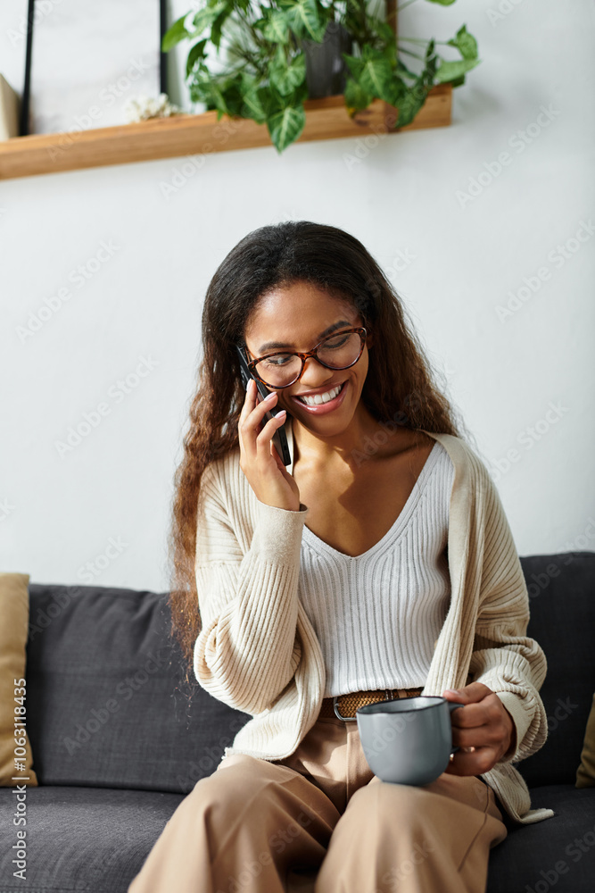 A cheerful woman chats on the phone while relaxing on her sofa, holding a cup of coffee. A cheerful woman chats on the phone while relaxing on her sofa, holding a cup of coffee.