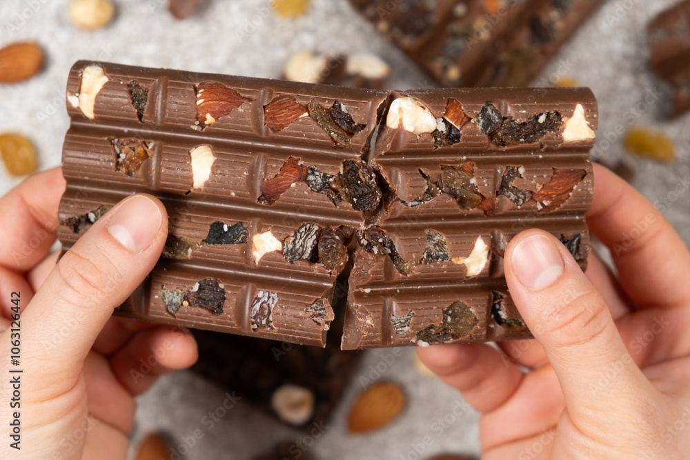 Broken chocolate bar in hands close-up view from above. Broken chocolate bar in hands close-up view from above.