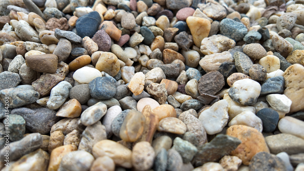 A close-up of colorful pebbles, highlighting natural texture, makes a perfect background for concepts of tranquility and outdoor exploration A close-up of colorful pebbles, highlighting natural texture, makes a perfect background for concepts of tranquility and outdoor exploration