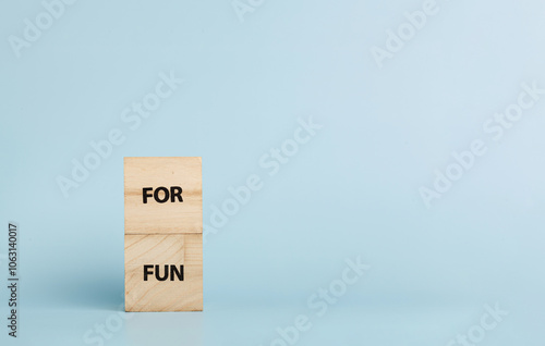 Wooden cubes with inscriptions For Fun on a blue background