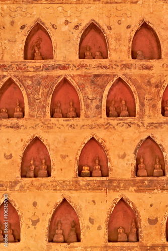 Many small, miniature buddha figurines, sculptures, statues are displayed in the cloister wall of the Wat Si Saket Temple, a buddhist temple in Vientiane, Laos