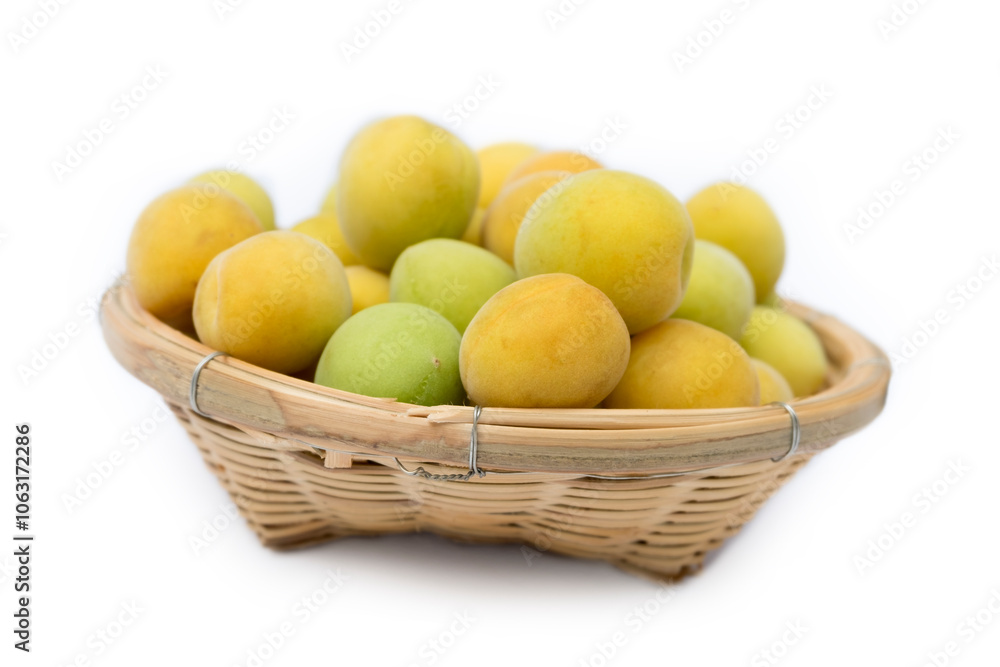 Fresh Ripe Plum Fruits in wooden basket isolated on white background close up Fresh Ripe Plum Fruits in wooden basket isolated on white background close up