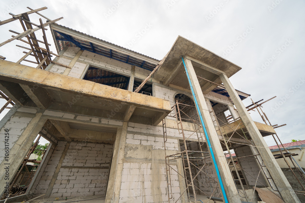 Under construction home or house with scaffolding on site in village. Old unfurnished rental property, living space units. lifestyle. Renovation. Under construction home or house with scaffolding on site in village. Old unfurnished rental property, living space units. lifestyle. Renovation.