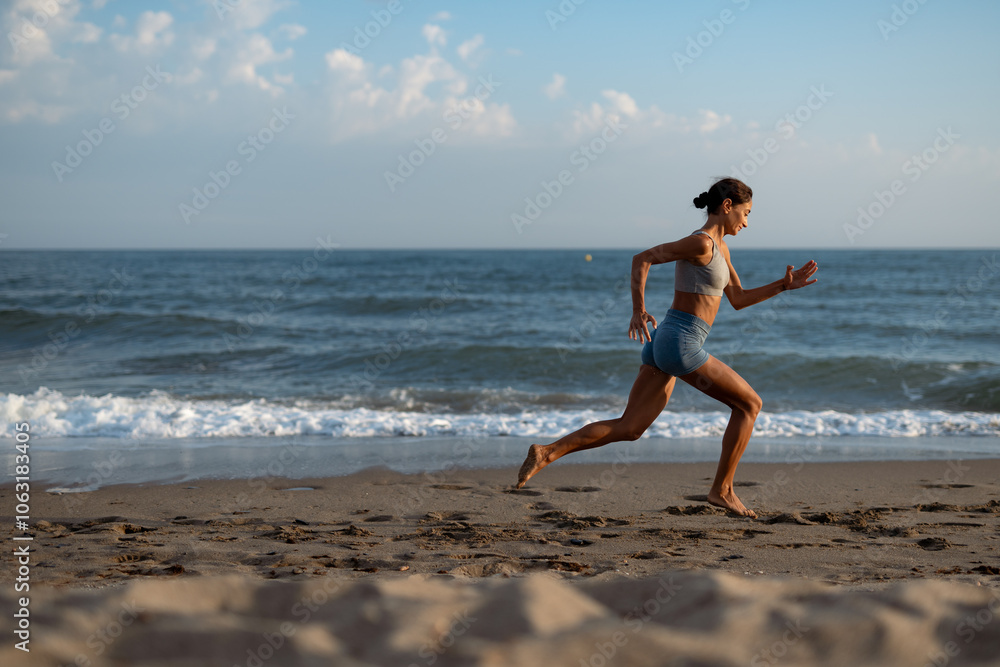 Fit Woman Running Along the Beach in the Morning Fit Woman Running Along the Beach in the Morning